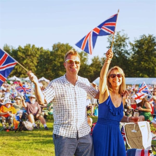 Summer Proms Spectacular for Two, Two people standing with flags alternative Summer Proms Spectacular for Two, Two people standing with flags alternative